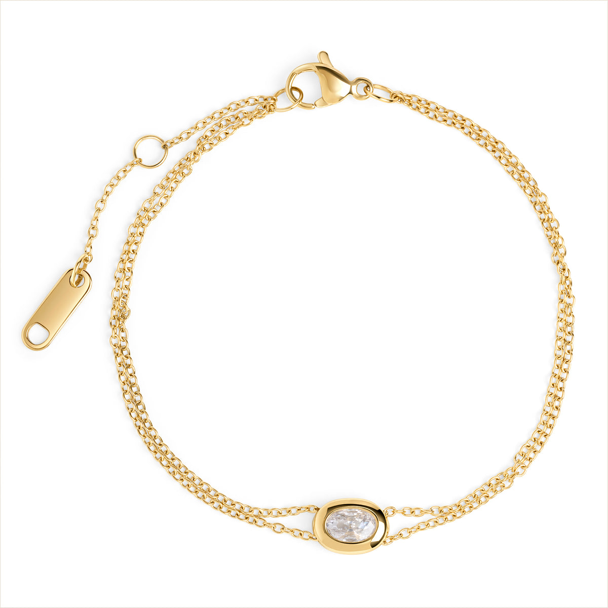 A double gold chain bracelet with an oval clear stone centerpiece, shown on a clean white background. Waterproof, stainless steel and allergy free. By Mia Bijoux Canada.
Bracelet à double chaîne dorée orné d'une pierre transparente ovale en son centre, présenté sur fond blanc épuré. Résistant à l'eau, en acier inoxydable et hypoallergénique. Par Mia Bijoux Canada.